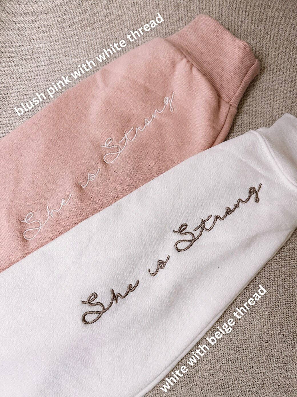 Our She Is Strong Embroidered Sweatshirt